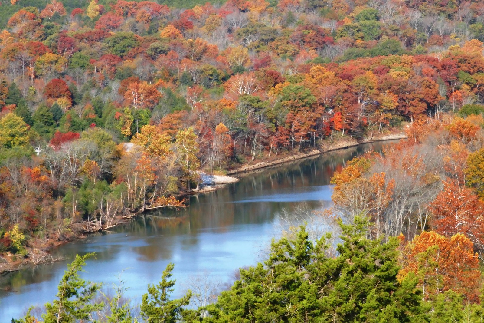 The White River curving past a hillside of orange, red and yellow trees.